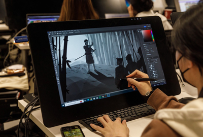 student drawing scene on tablet