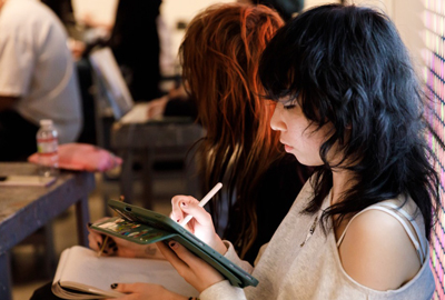 student drawing on tablet