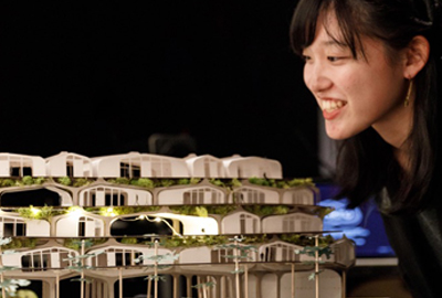 student looking at architecture model