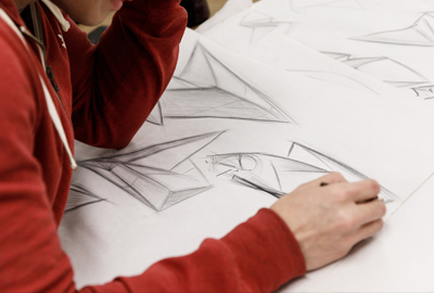 student drawing car prototype