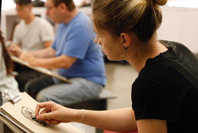 Students drawing a figure in class